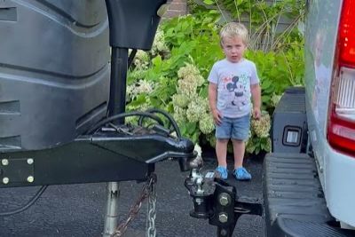 Kid Helps Dad To Line Up Trailer