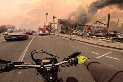 Motorcyclist Rides Through The Burned City Of Los Angeles