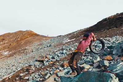 Rolling A Tyre Off Of A Mountain Followed By A Drone