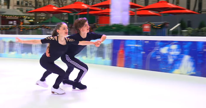 Couple Skates On Ice While 
