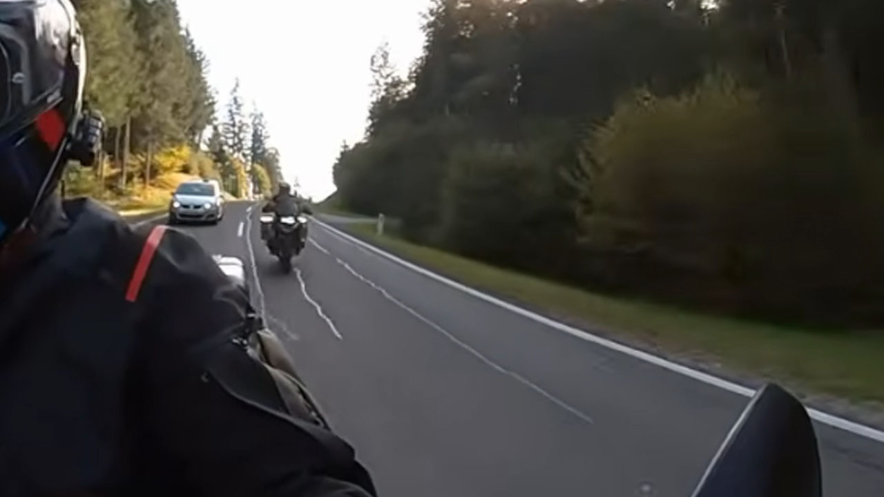 Motorcyclist riding through the Italian Alps moments before his friend leaves the road