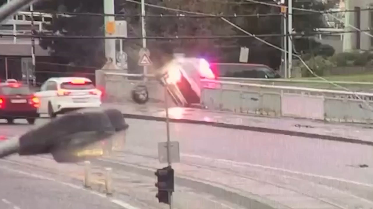 Police car moments before plunging into the Vltava River from Hlávkův Bridge in Prague